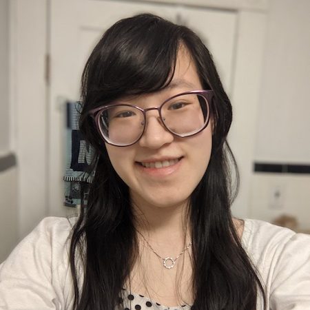 Anna Wang in a gray shirt and glasses